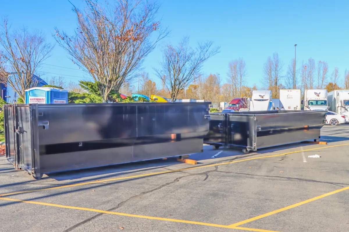 Professional dumpster rental service with roll-off container on residential driveway in Providence Village